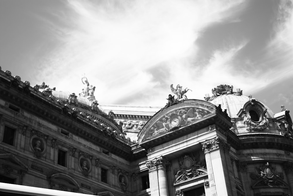 a black and white photo of a building with a clock