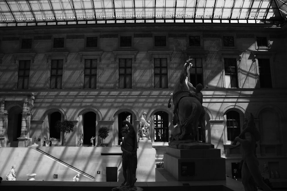 a black and white photo of a statue of a man on a horse