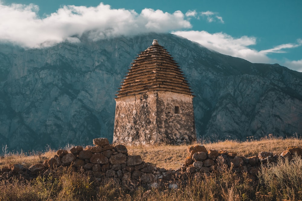 a stone structure with a mountain in the background