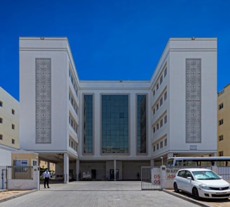a white car parked in front of a building