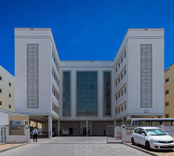 a white car parked in front of a building