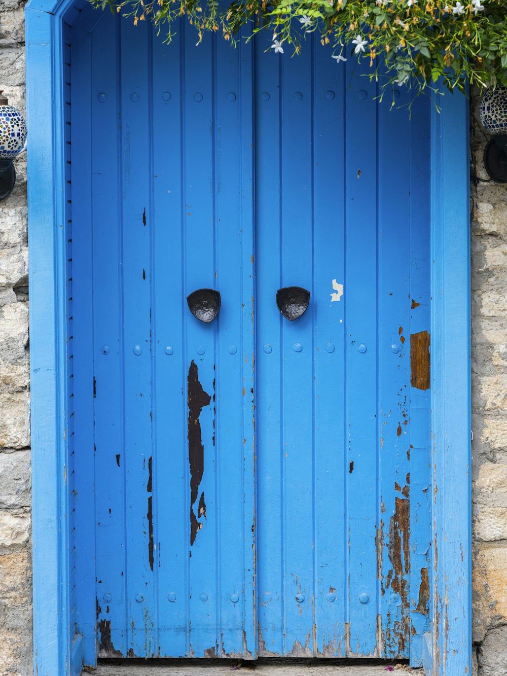 a blue door with two faces on it