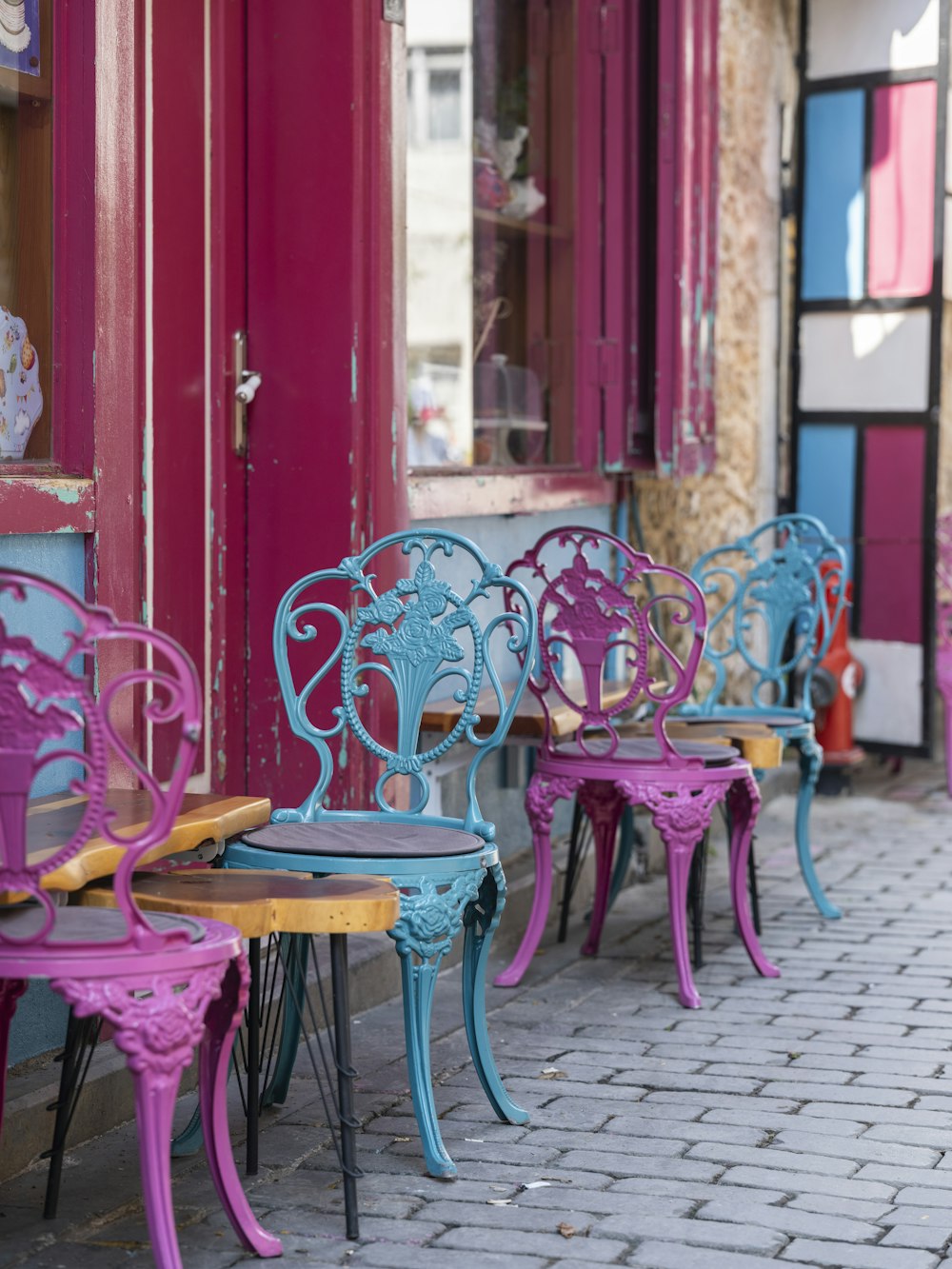 a row of pink and blue chairs sitting next to each other
