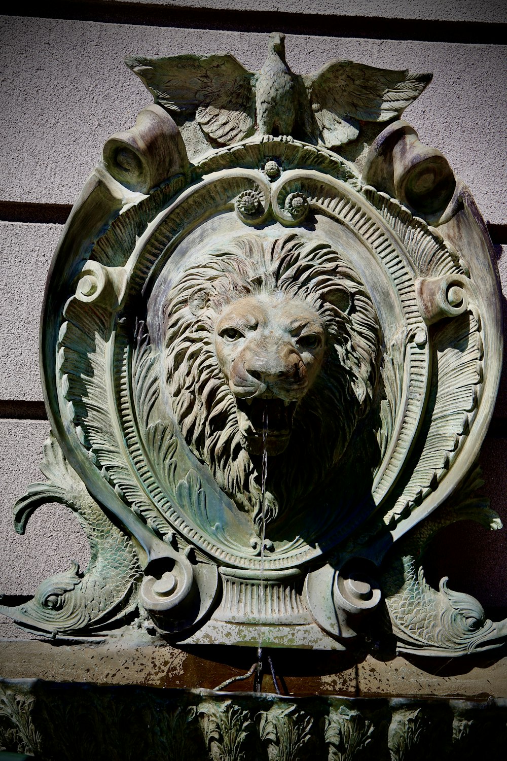 a statue of a lion head on a building