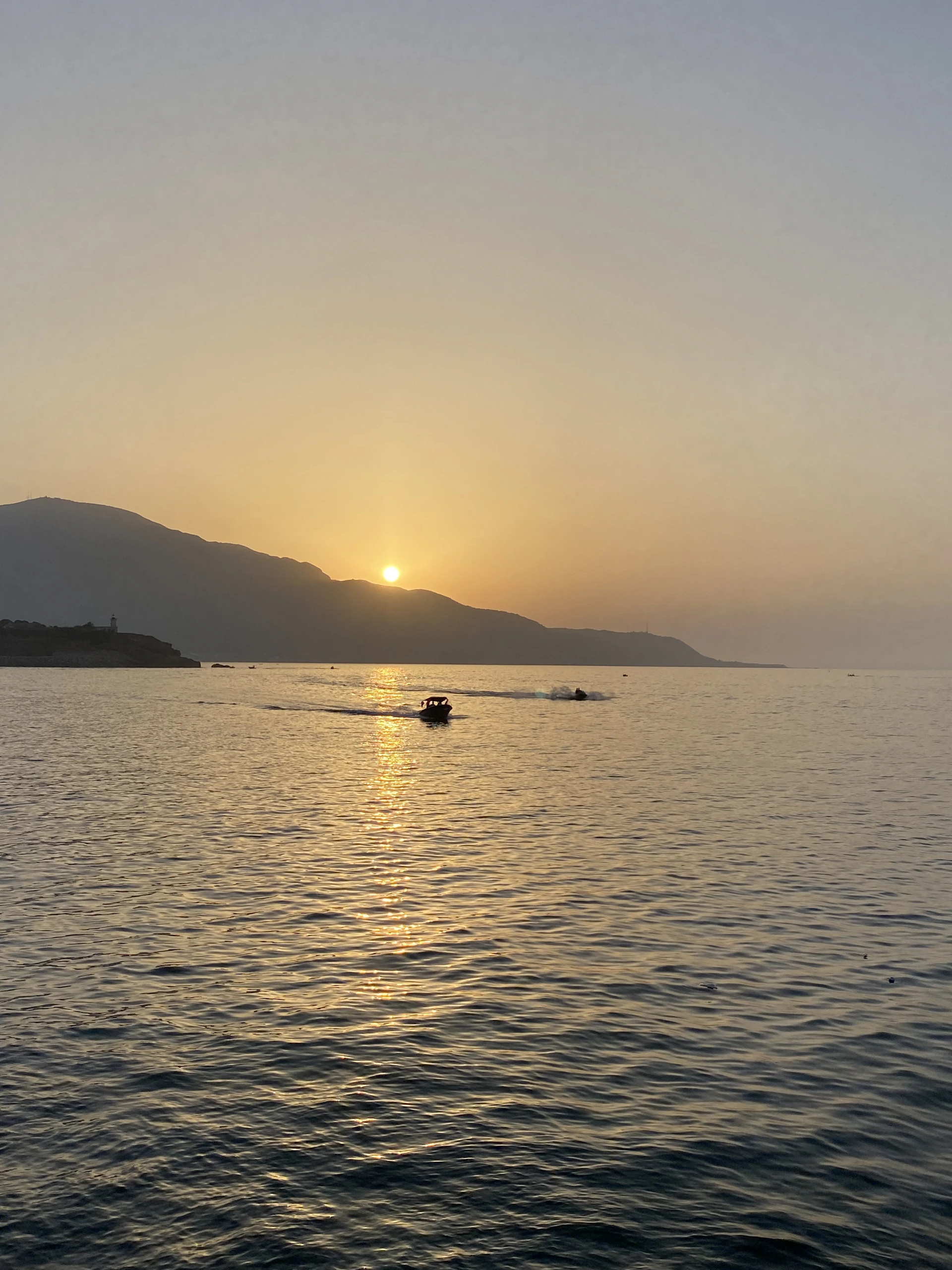 the sun is setting over a body of water