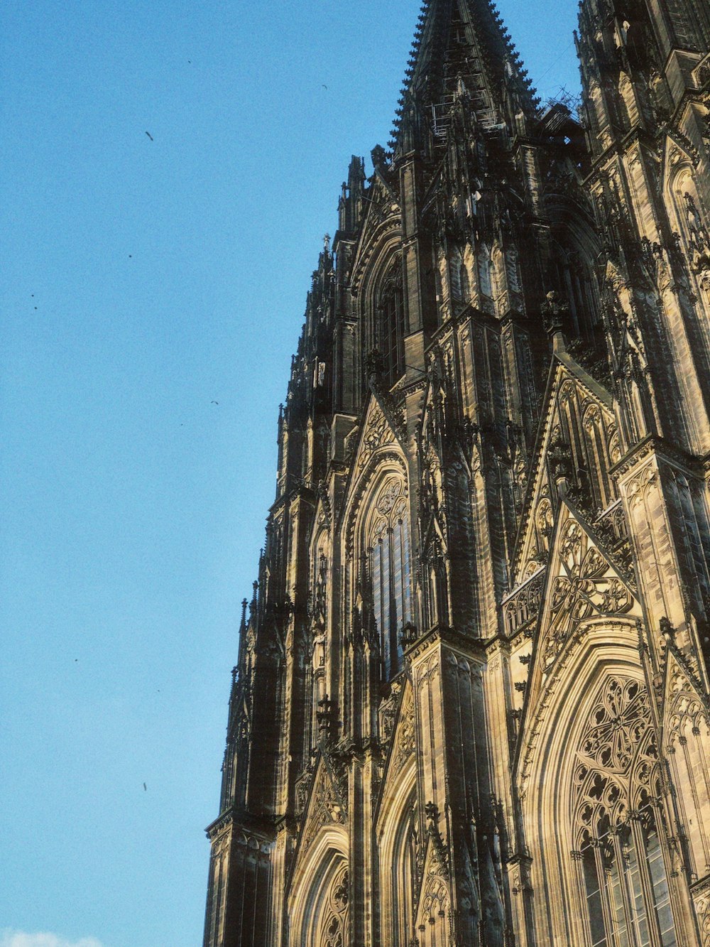 a very tall cathedral with a clock on it's side