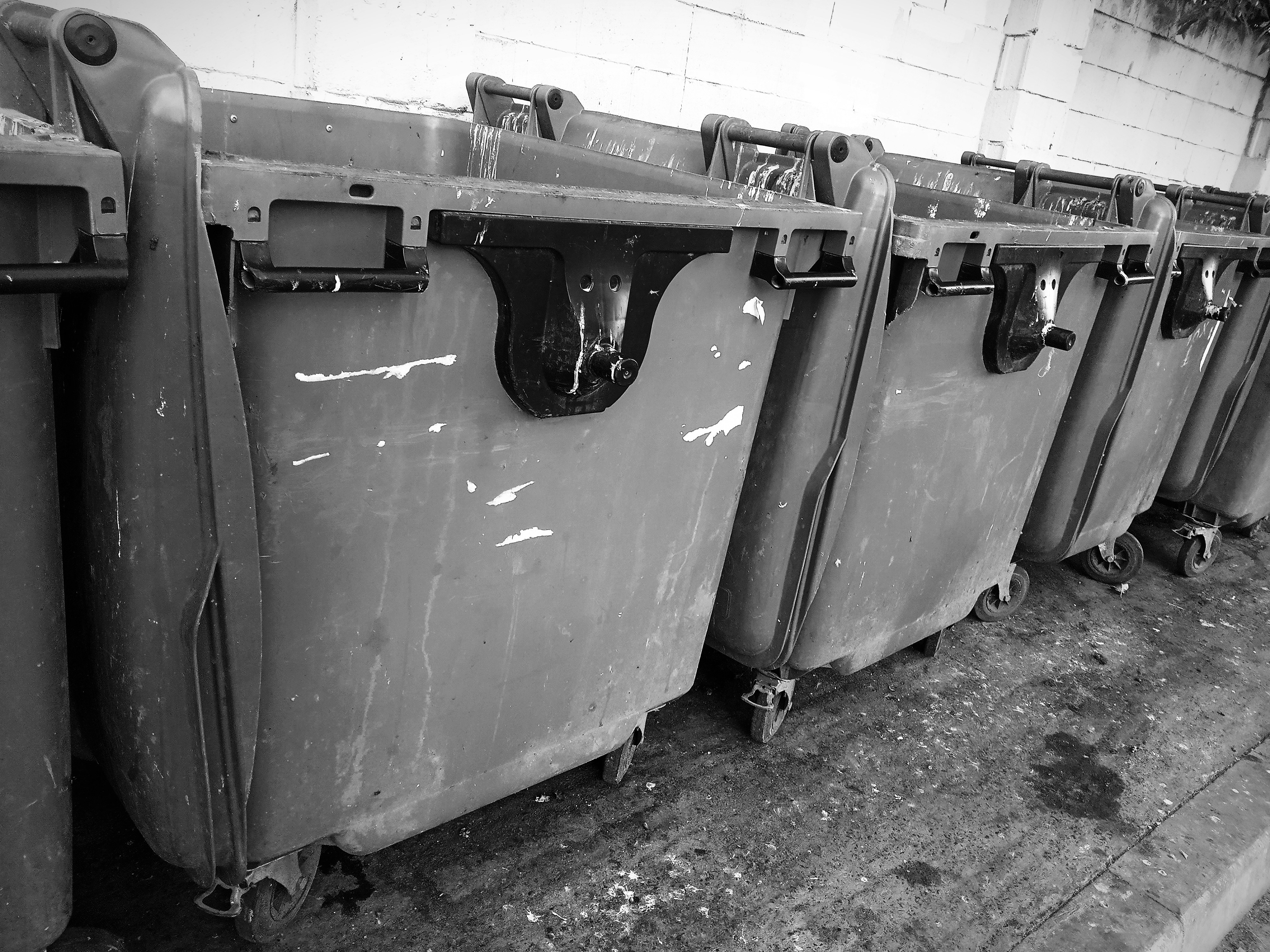 black and white photograph of a row of old refrigerators