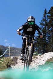 Mountain biker wearing rugged sports sunglasses on a trail