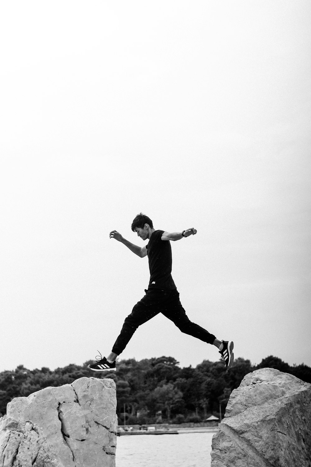 a man jumping off a rock into the air