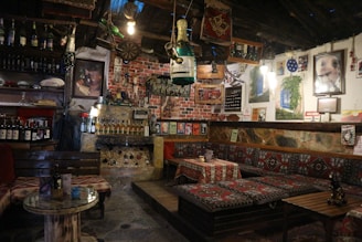 Cozy, historic interior of a traditional Andalusian tavern with rustic wooden tables and warm lighting.