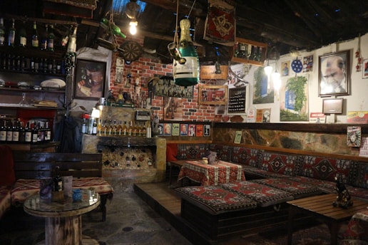 A dimly lit cantina interior with rustic wooden tables and colorful alien decor, evoking a cozy and worn atmosphere.