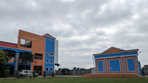 Exterior view of mango63 hostel building in Jaipur under clear skies.