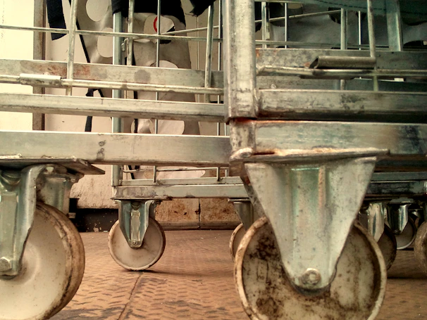 Close-up of the durable wheels of the platform cart on a warehouse floor