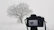 Close-up of a camera capturing the vibrant winter landscape of Riisitunturi National Park.