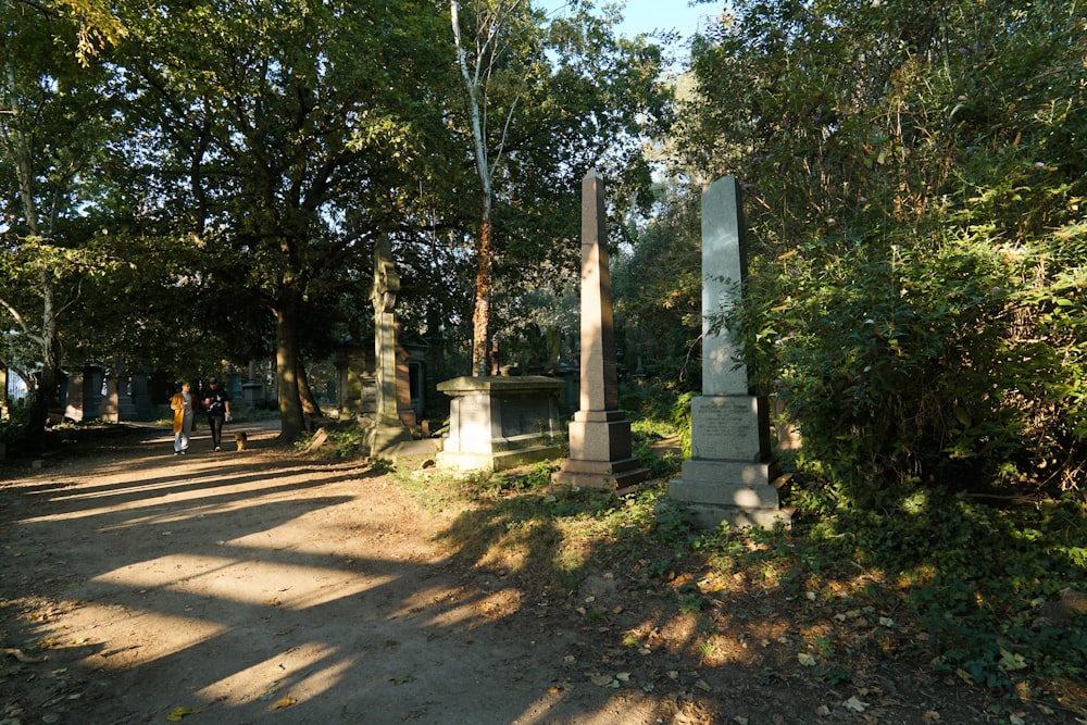 a couple of pillars sitting in the middle of a forest