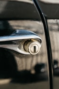 Close-up image of a car door lock being carefully unlocked without damage.
