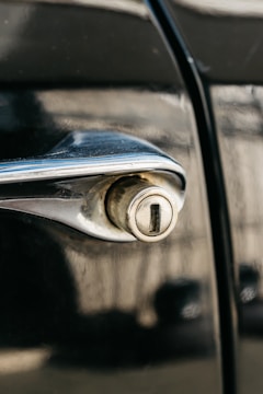 Close-up image of a car door lock being carefully unlocked without damage.