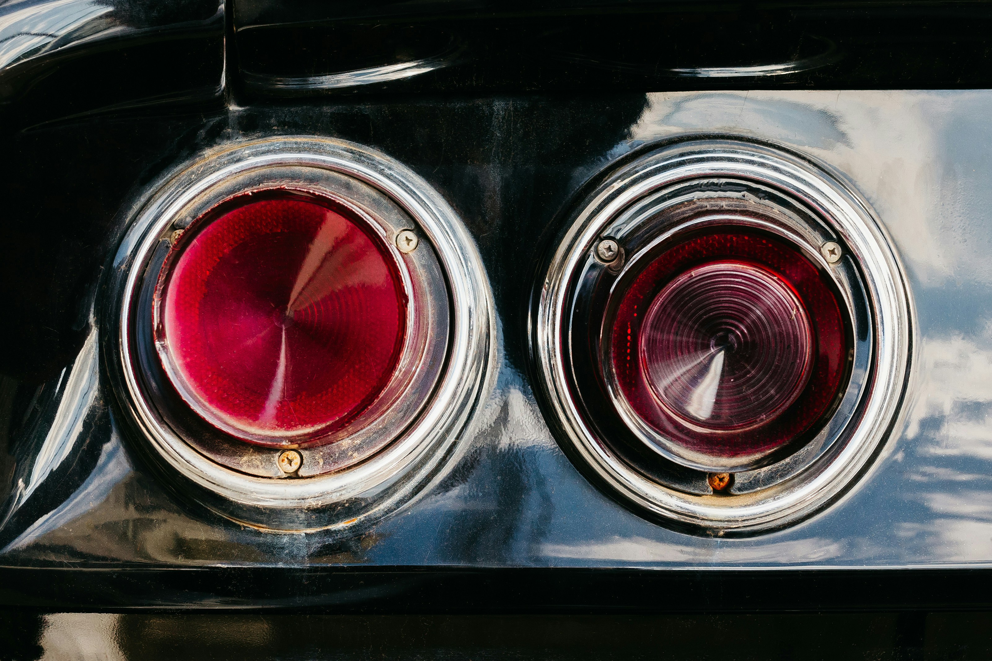 a close up of the tail lights of a classic car