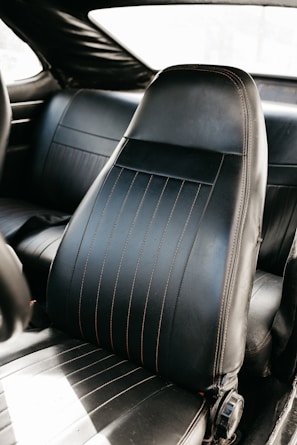 Close-up of a car seat before and after professional shampoo cleaning, showing deep stain removal.