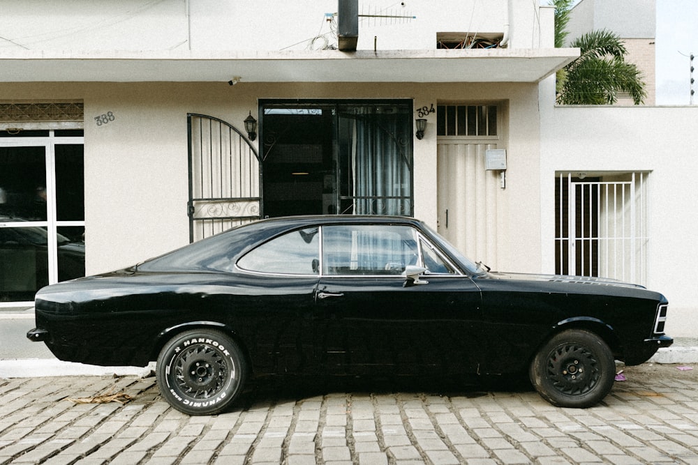a black car parked in front of a building