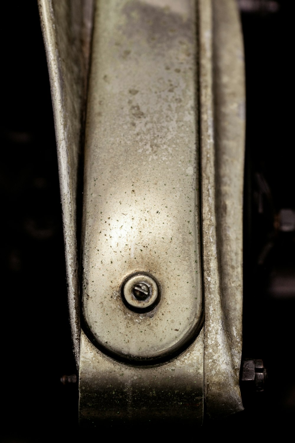 a close up of a metal object with a black background