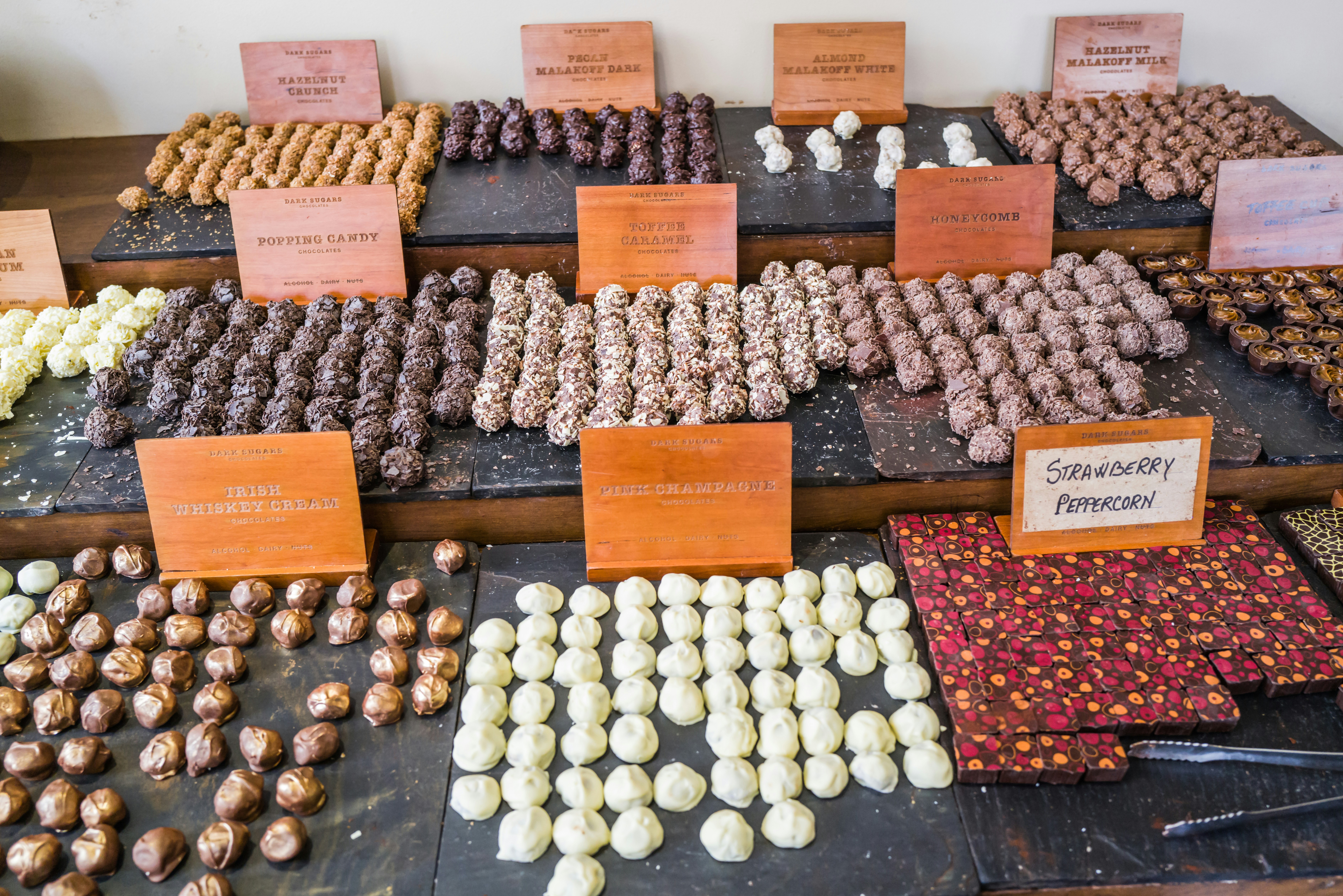 a display case filled with lots of different types of doughnuts