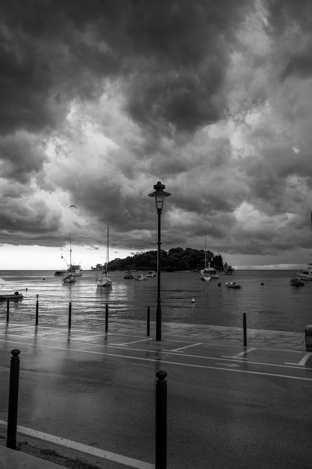 a black and white photo of boats in the water