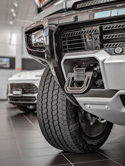 Close-up of a sleek tow hook securing a vehicle under soft lighting