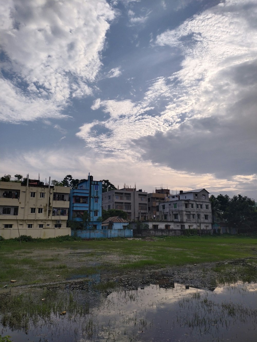 a large building sitting on top of a lush green field