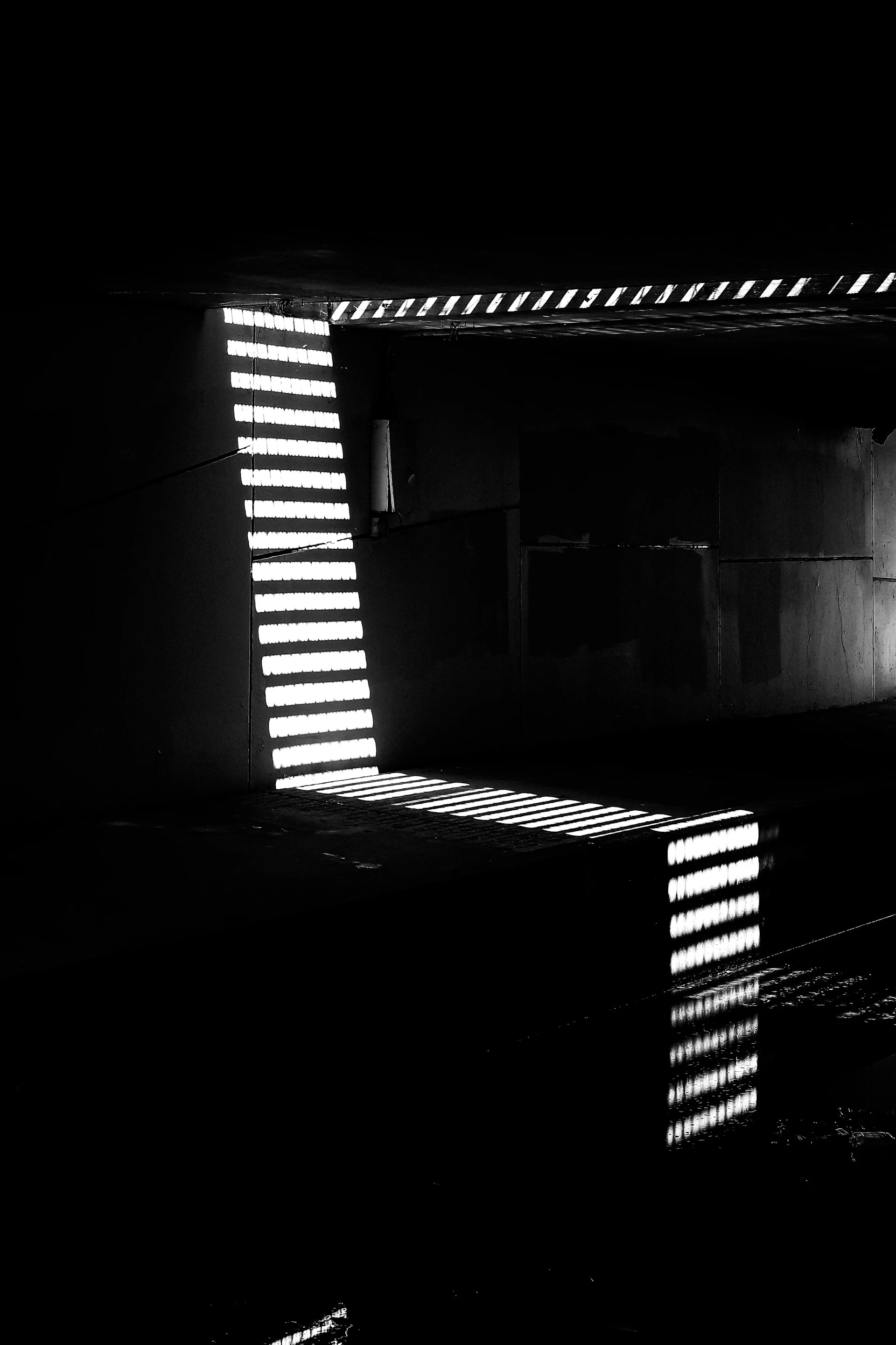 a black and white photo of a building in the dark