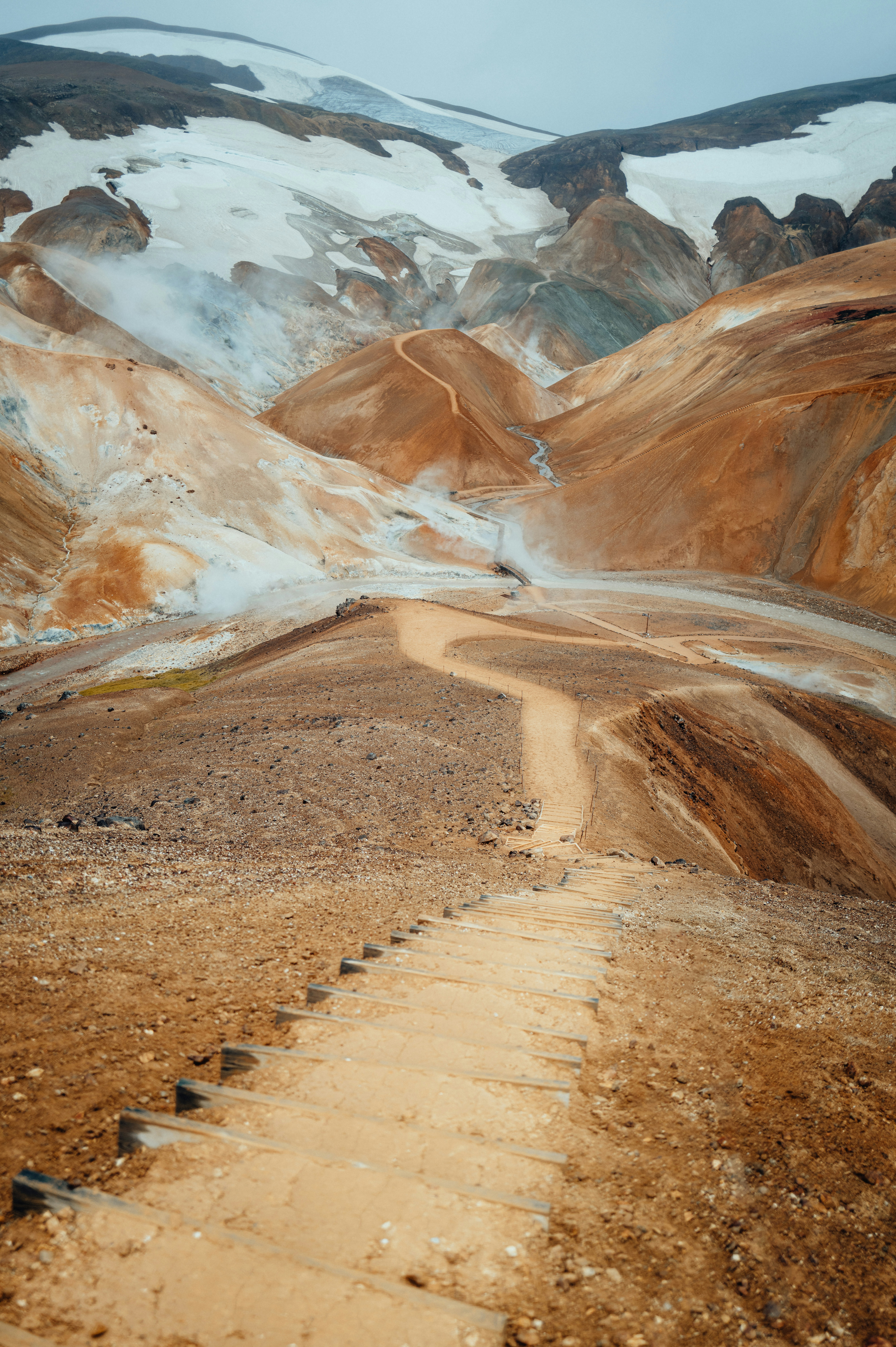 a dirt road in the middle of a mountain range