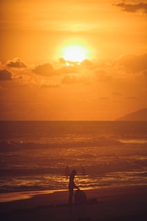 A scenic sunset over a Brittany beach with golden sands.