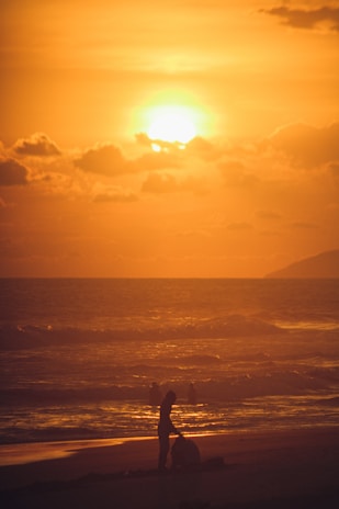 A scenic sunset over a Brittany beach with golden sands.