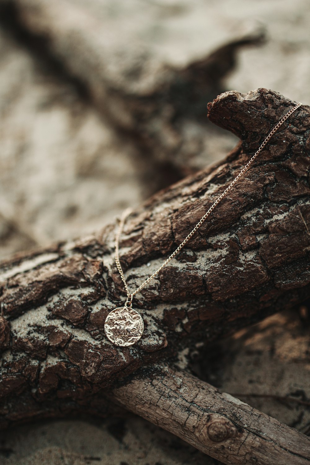 a close up of a cross on a tree branch