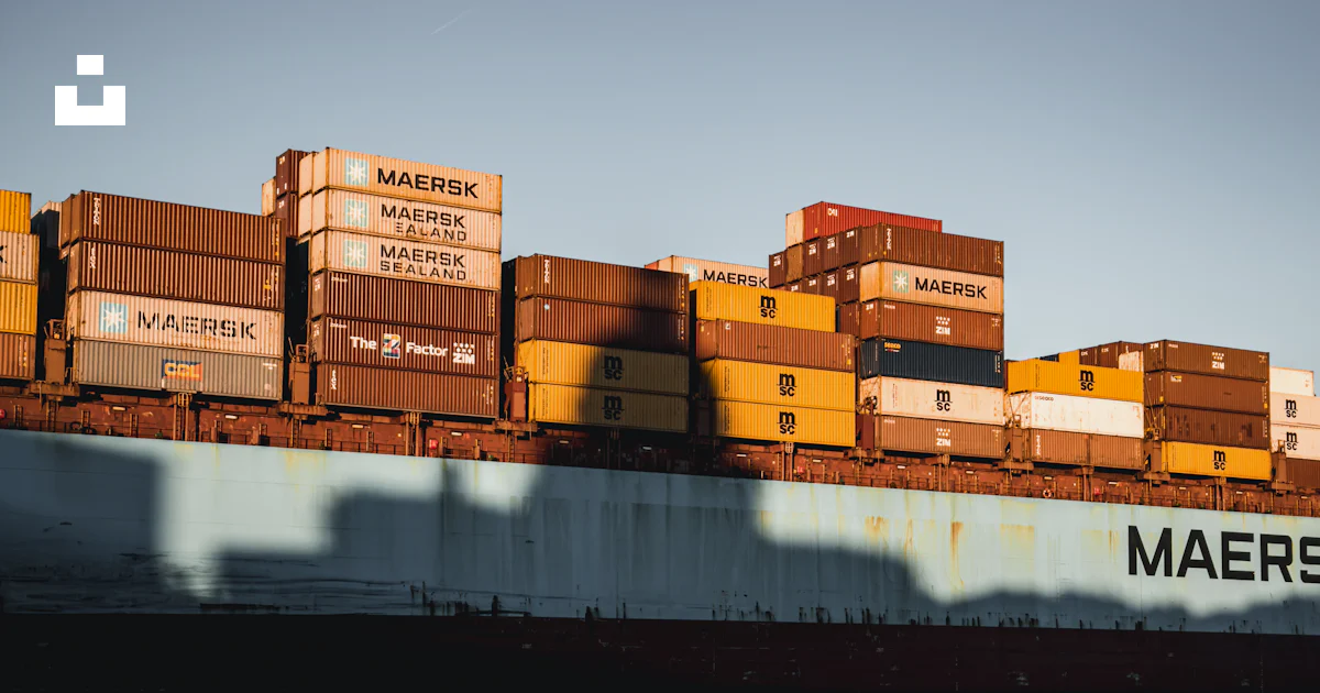 A large cargo ship with stacks of boxes on top of it photo – Free Usa ...