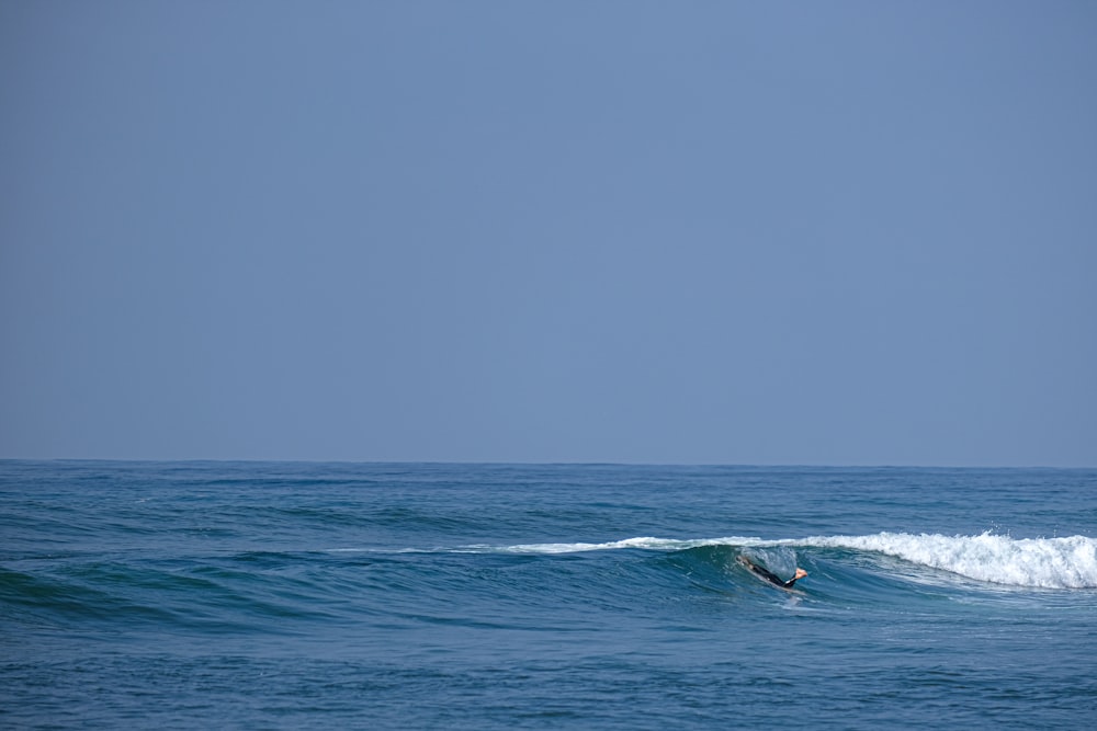 a person riding a surfboard on a wave in the ocean