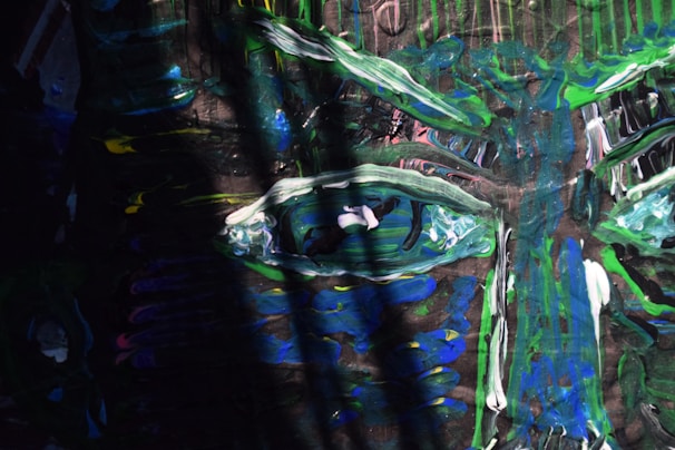 Close-up of a trippy, abstract cartoon eye with swirling patterns and dark hues.