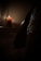 A serene setting with a lit candle casting a warm glow.