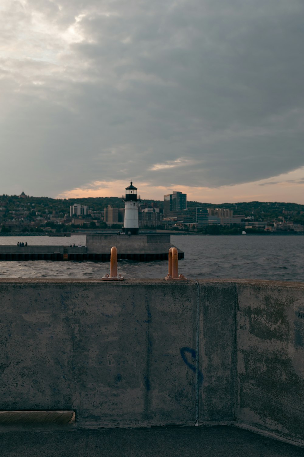 a light house sitting on top of a cement wall