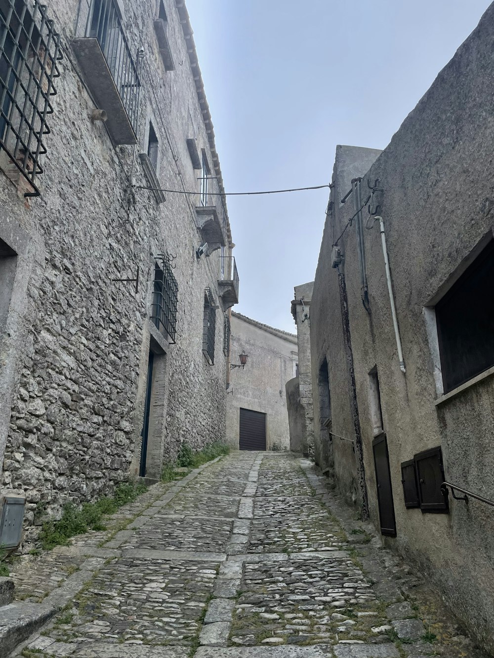 a narrow cobblestone street in an old town