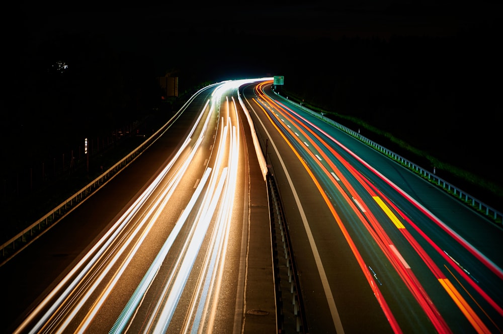 a long exposure photo of a highway at night