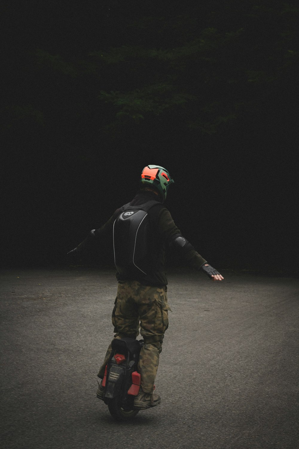 a man riding a skateboard down a street