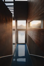 a room with a glass floor and a view of the water