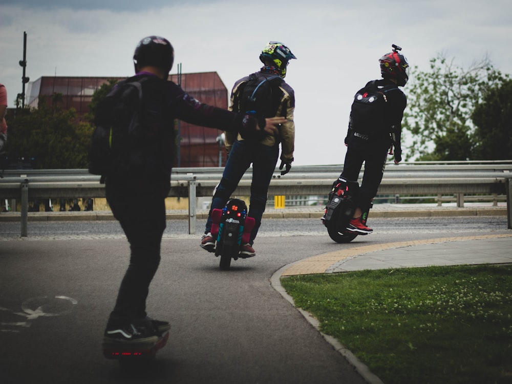 a group of people riding skateboards down a street