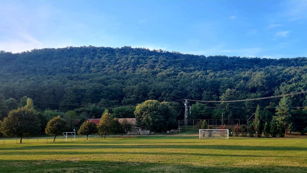 a soccer field in front of a mountain