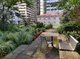 A small garden patio designed with smart space use, blending greenery and seating harmoniously.
