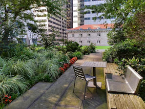Backyard garden with blooming flowers and a small patio.