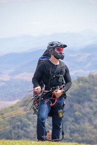 a man with a helmet and goggles holding a kite