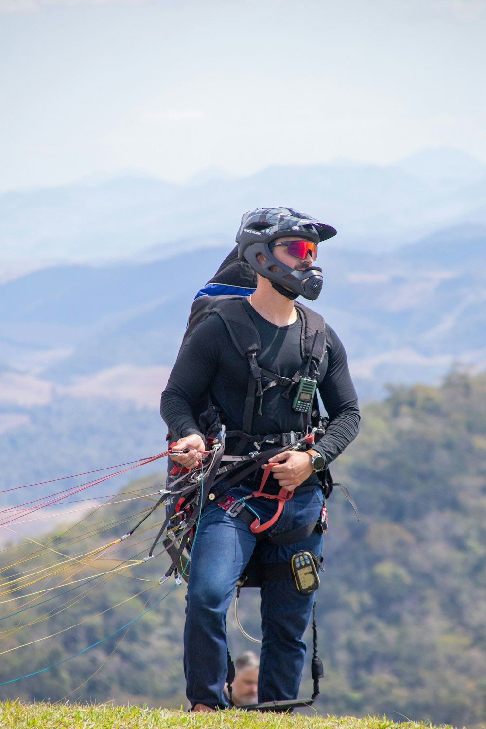 a man with a helmet and goggles holding a kite