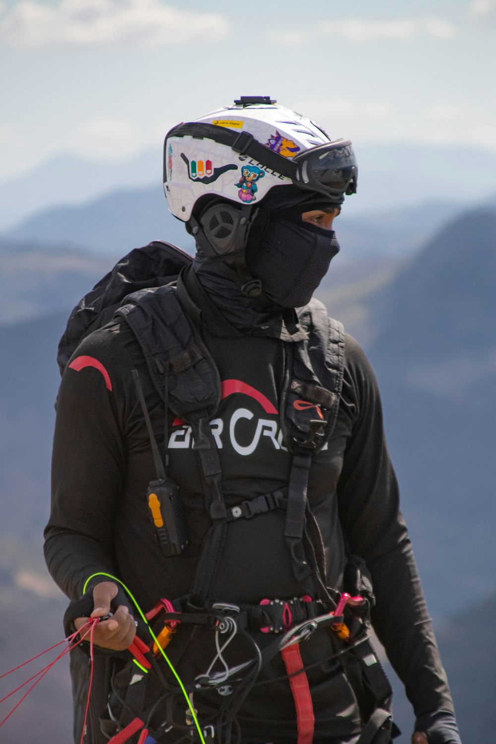 a man wearing a helmet and holding a kite